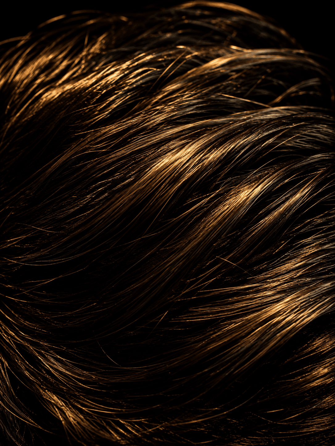 Close-up of healthy golden hair strands representing men's hair restoration and regrowth at Men's Vitality Clinic Vancouver